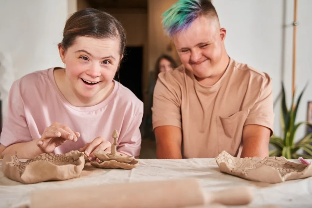 Two disabled friends with down syndrome in art class