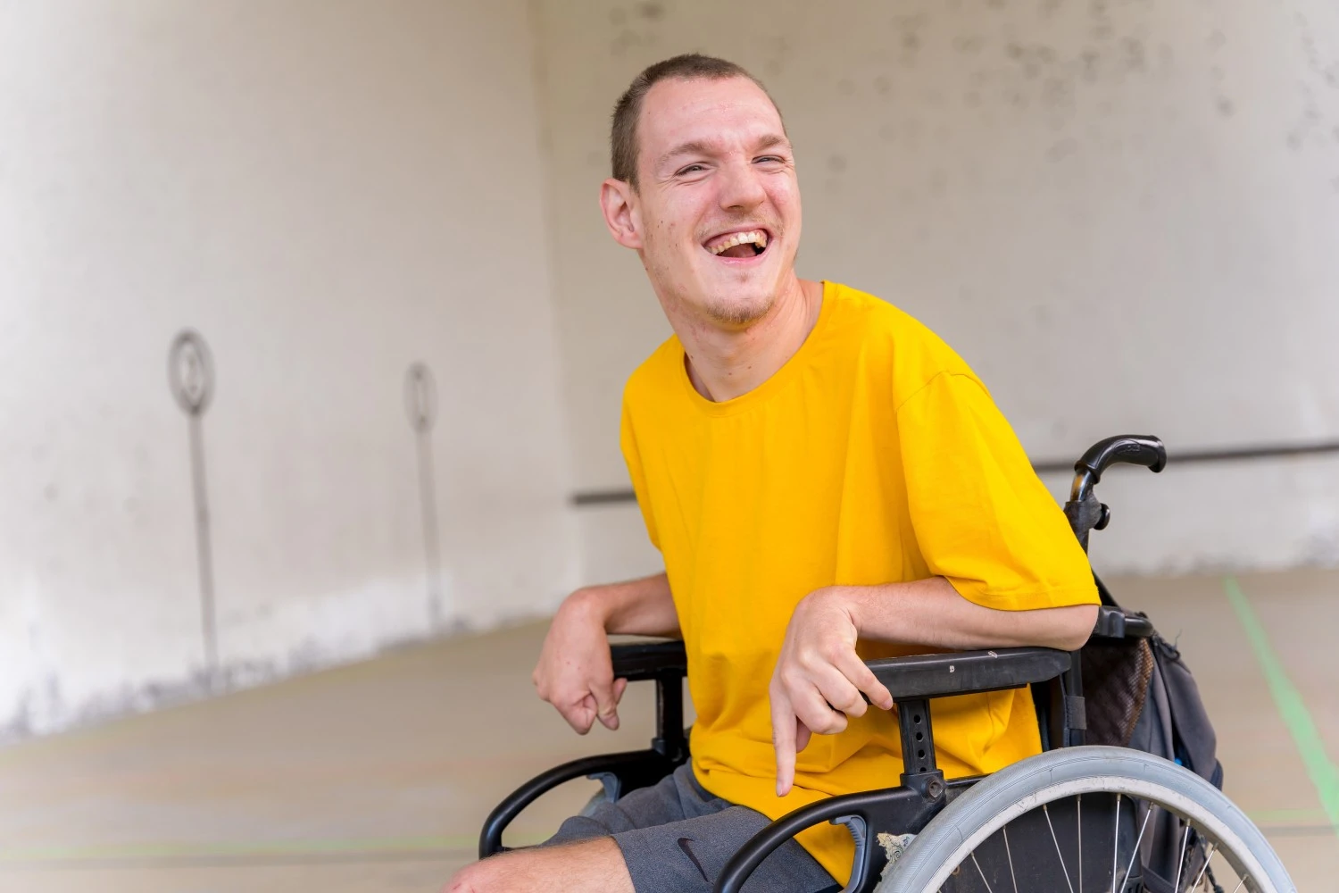 Happy disabled man in wheelchair smiling at camera