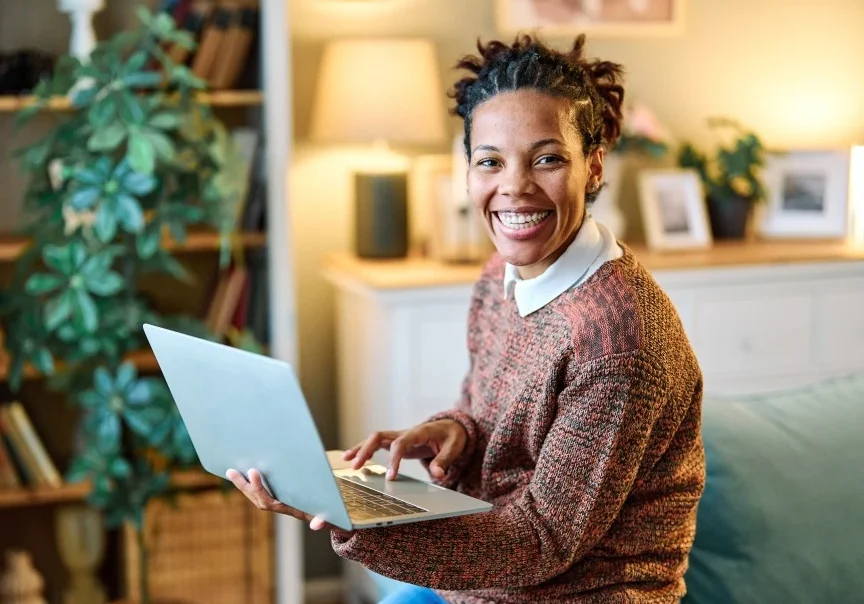 Happy woman using laptop to make an NDIS referral